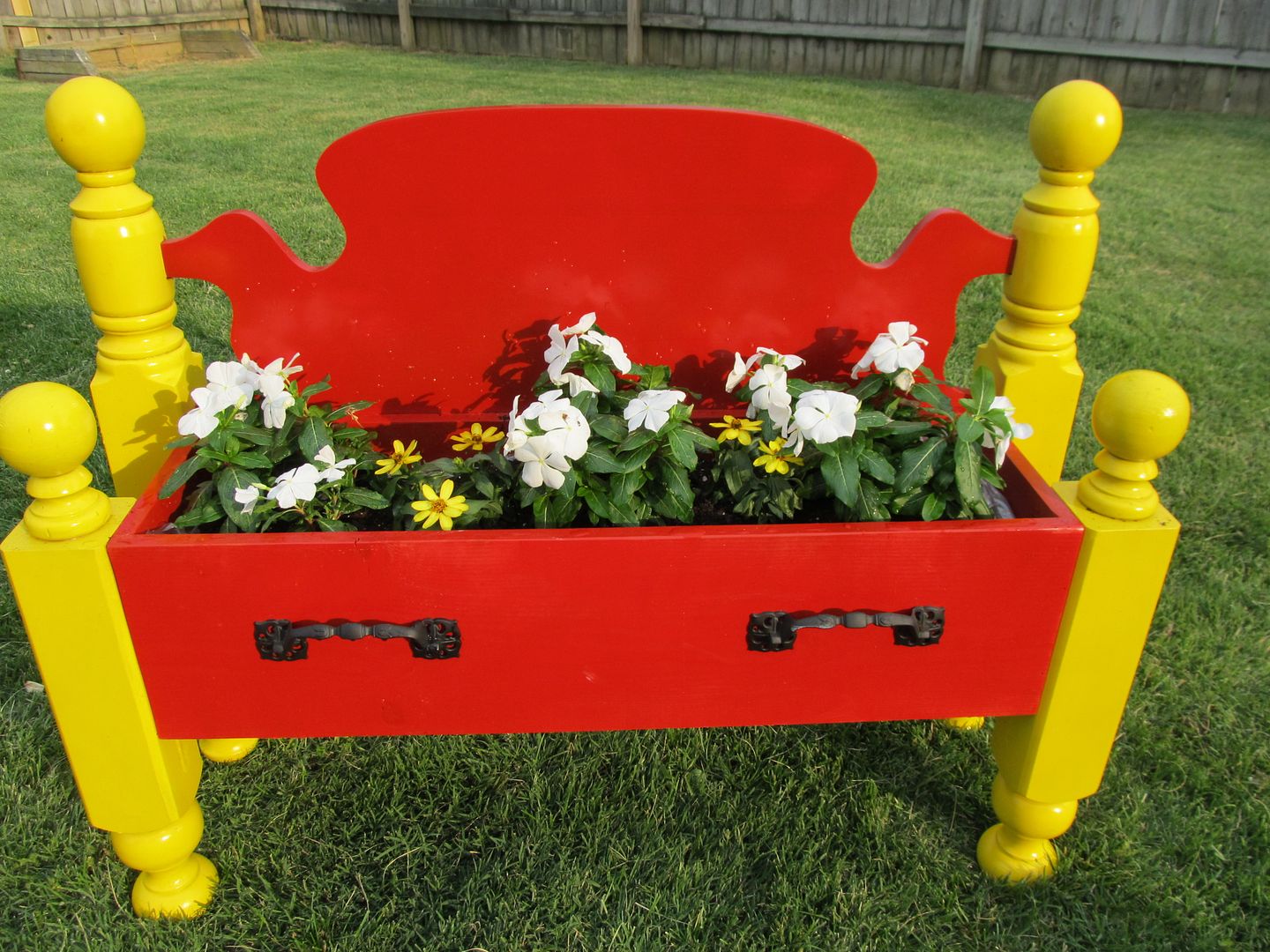 repurposed bed into a flower bed